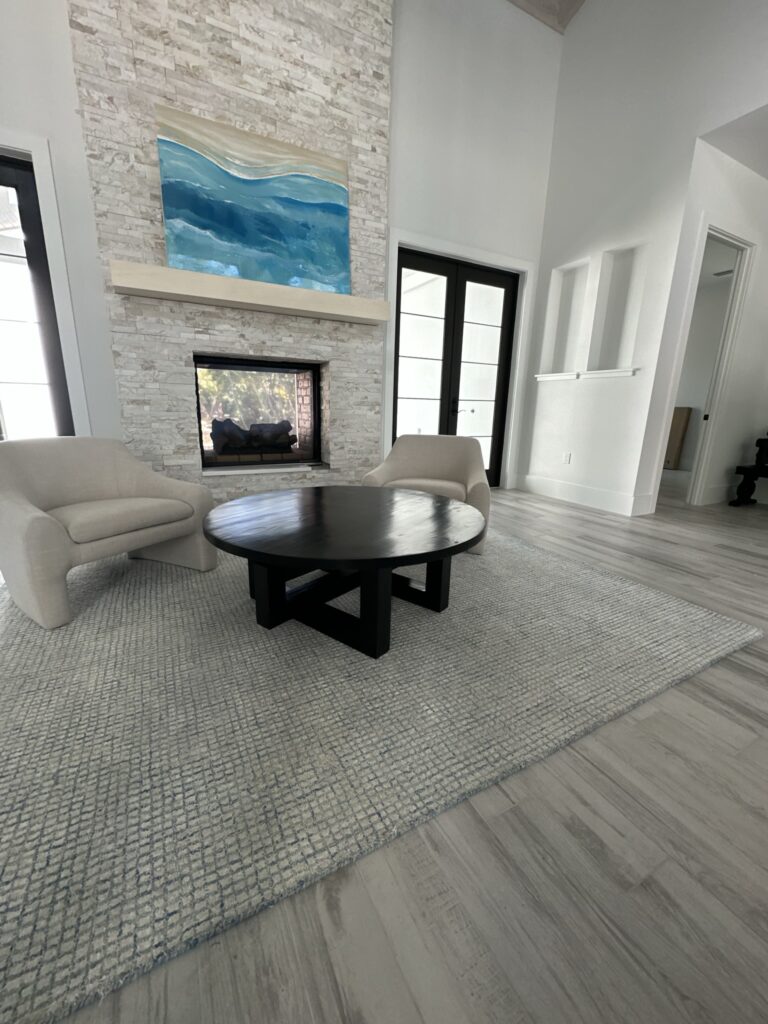 The Jupiter Island Modern Coffee Table features a striking round hardwood top with bold geometric legs. A sculptural centerpiece for contemporary living.