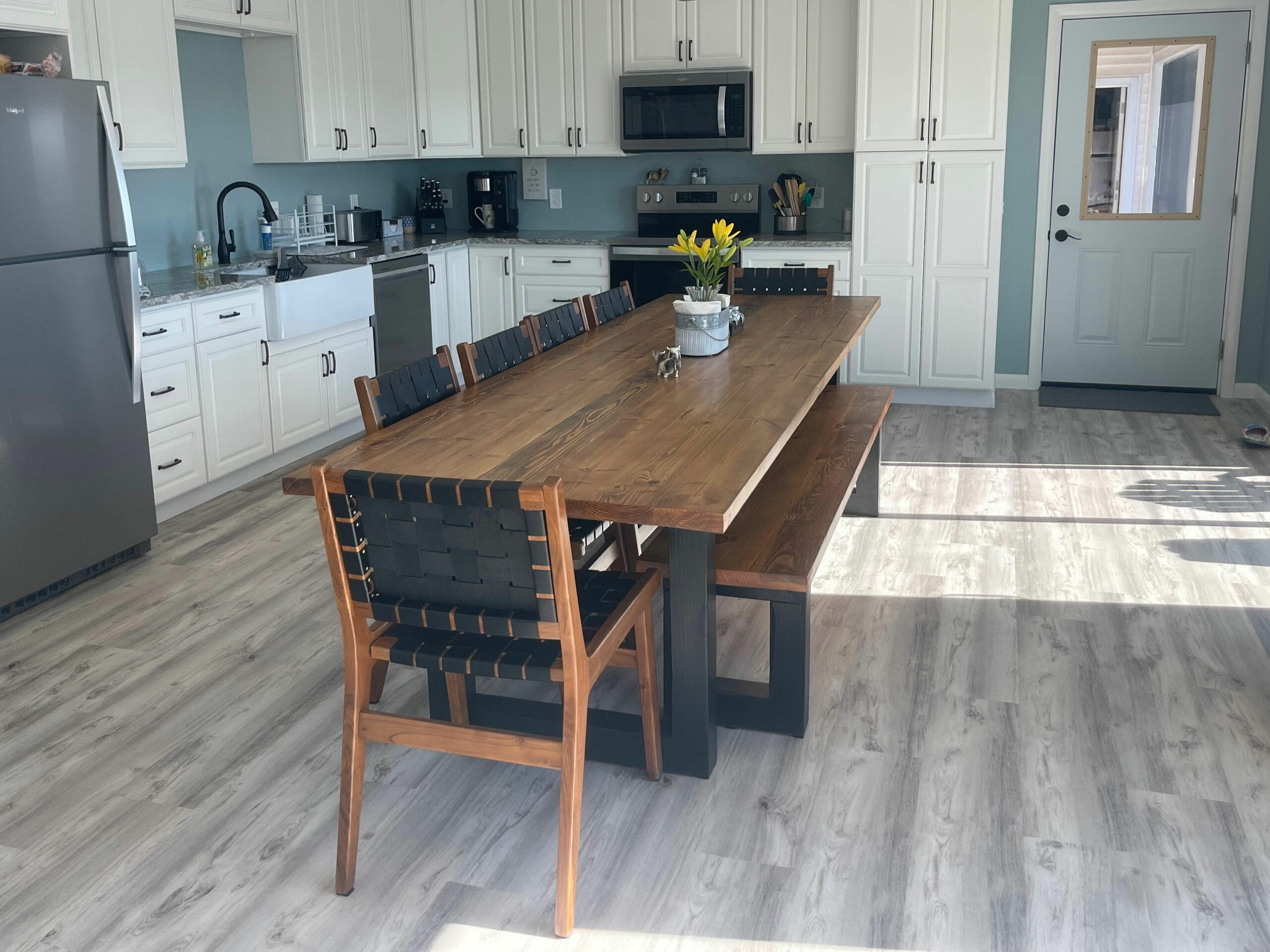 A sleek blend of industrial form and natural finish, the Flagler Modern Table brings warmth and edge to your space with bold black legs and a richly grained wood top.
