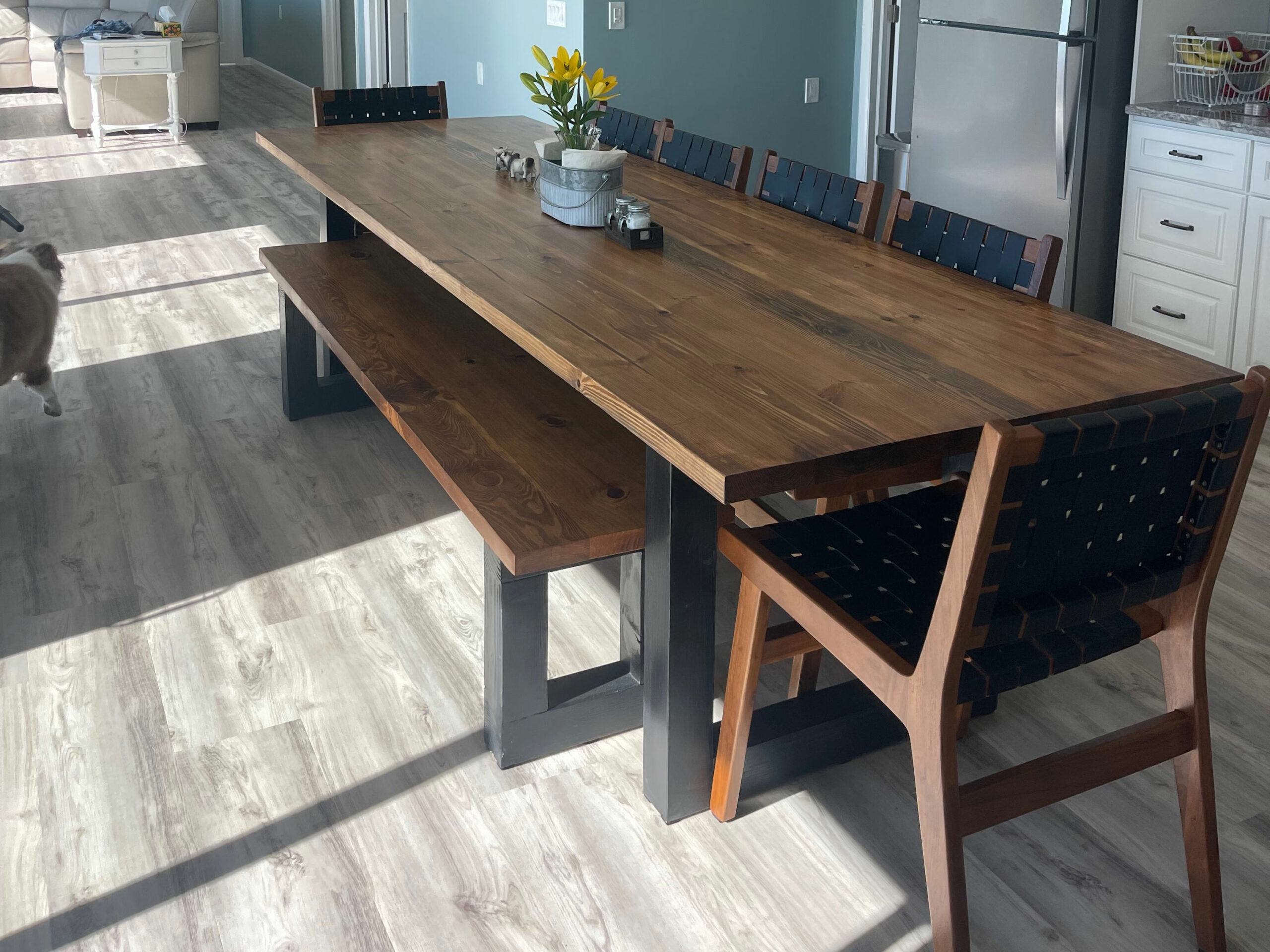 A sleek blend of industrial form and natural finish, the Flagler Modern Table brings warmth and edge to your space with bold black legs and a richly grained wood top.